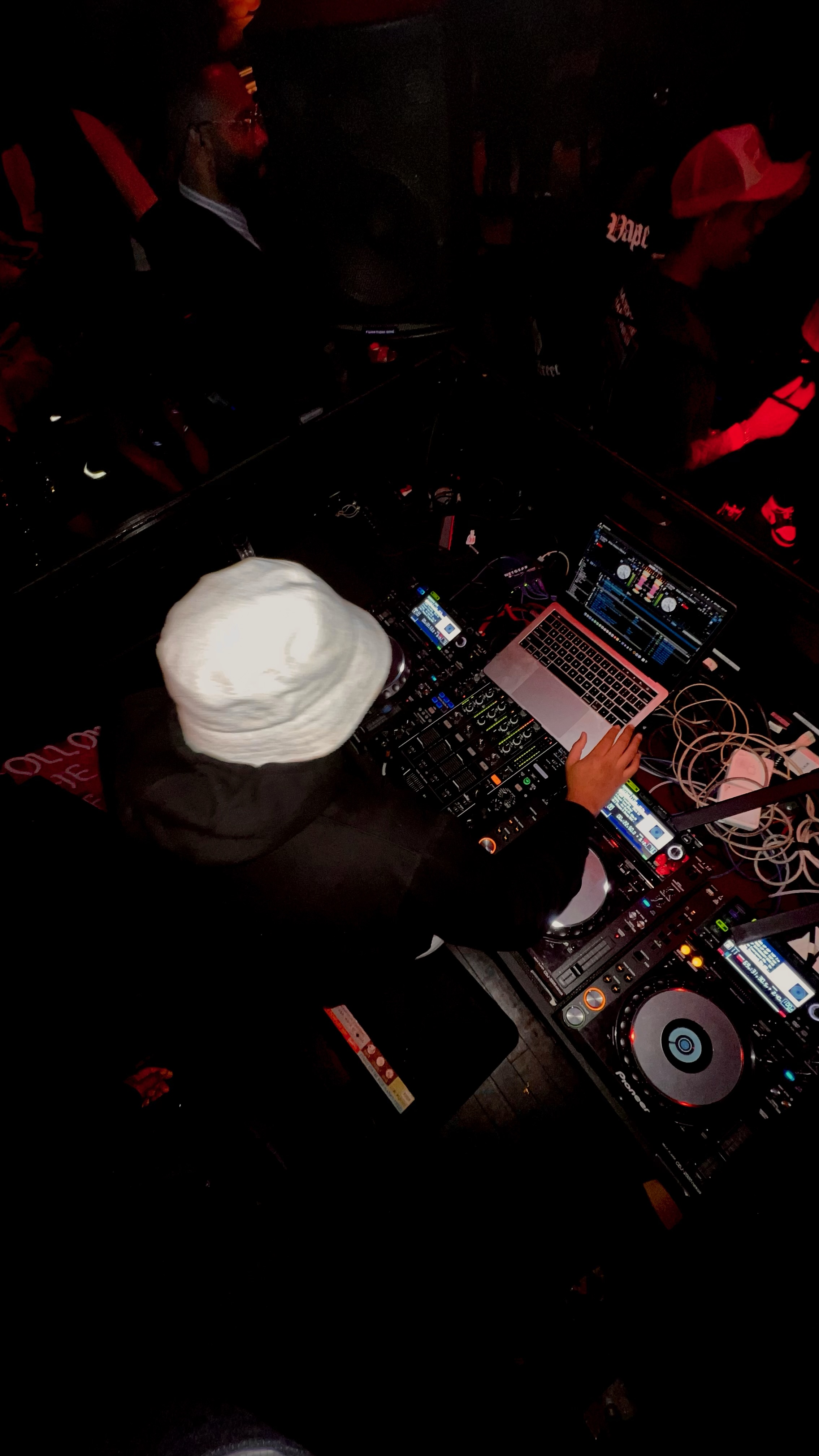 Nomadiq at the decks in a nightclub